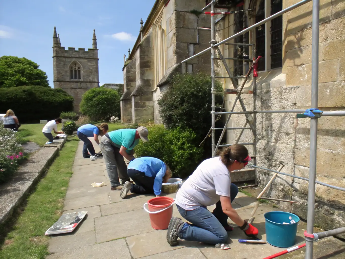 A team of preservationists carefully restoring a historical monument in Saintonge Maritime, showcasing their expertise and dedication to preserving the region's architectural heritage.
